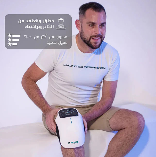 Man holding a white electronic device with Arabic text and branding on a light background